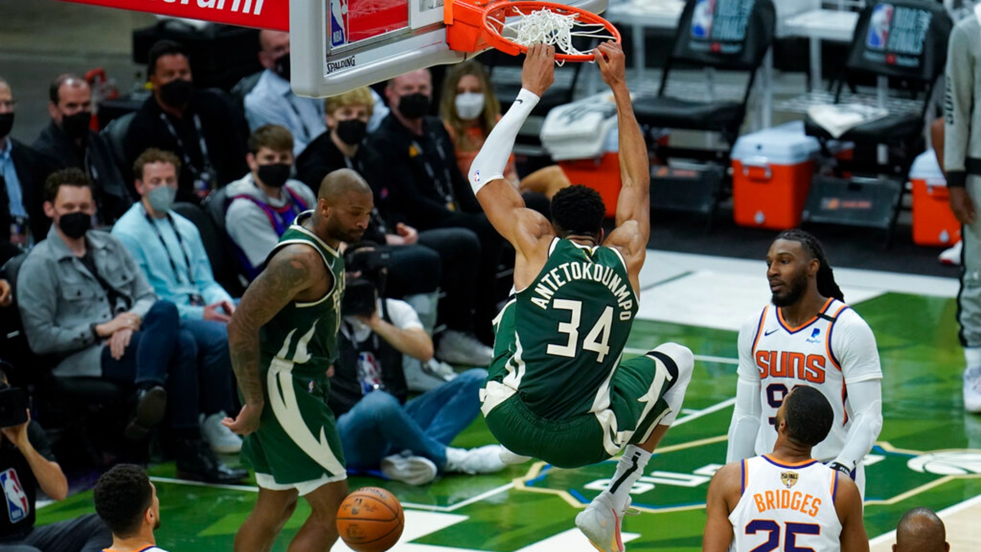 Milwaukee Bucks' Giannis Antetokounmpo (34) dunks during the first half of Game 3 of basketball's NBA Finals against the Phoenix Suns in Milwaukee, Sunday, July 11, 2021. (AP Photo/Paul Sancya)