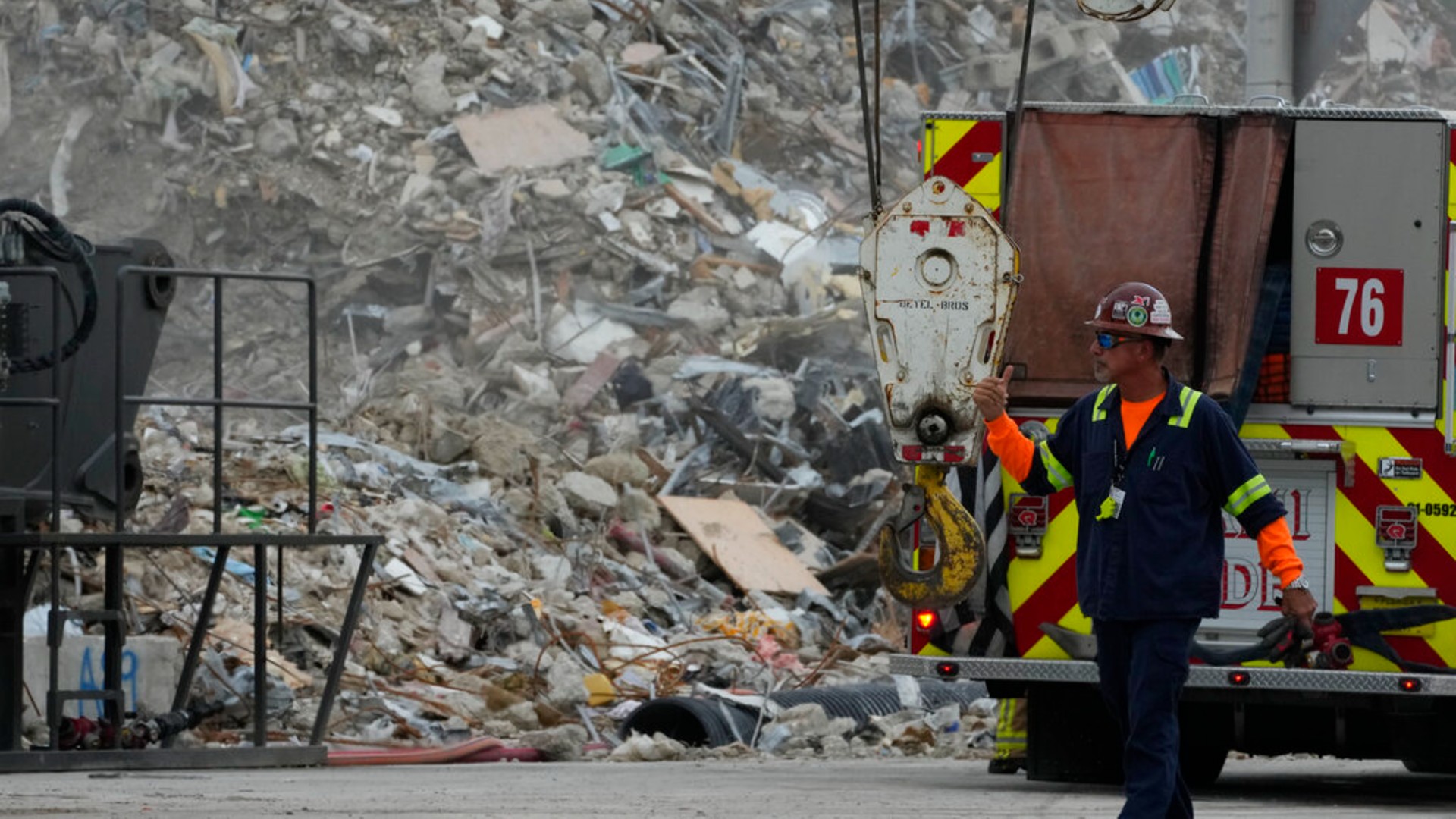 Crews work in the rubble of the demolished section of the Champlain Towers South building, as removal and recovery work continues at the site of the partially collapsed condo building, on Monday, July 12, 2021, in Surfside, Fla.(AP Photo/Rebecca Blackwell)