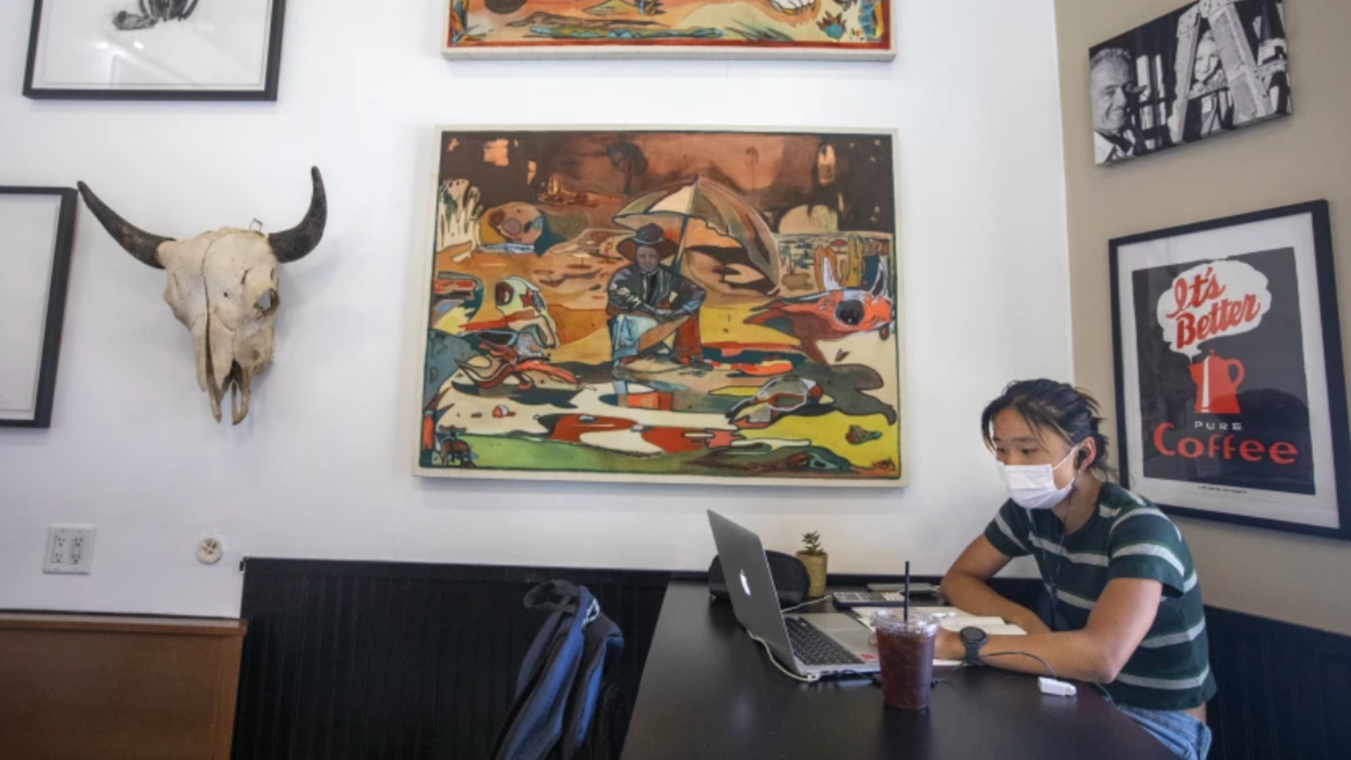 Lilian Zhu, 17, works on her laptop while wearing a face mask inside Charlie’s Coffee House in South Pasadena on Sunday.(Francine Orr / Los Angeles Times)