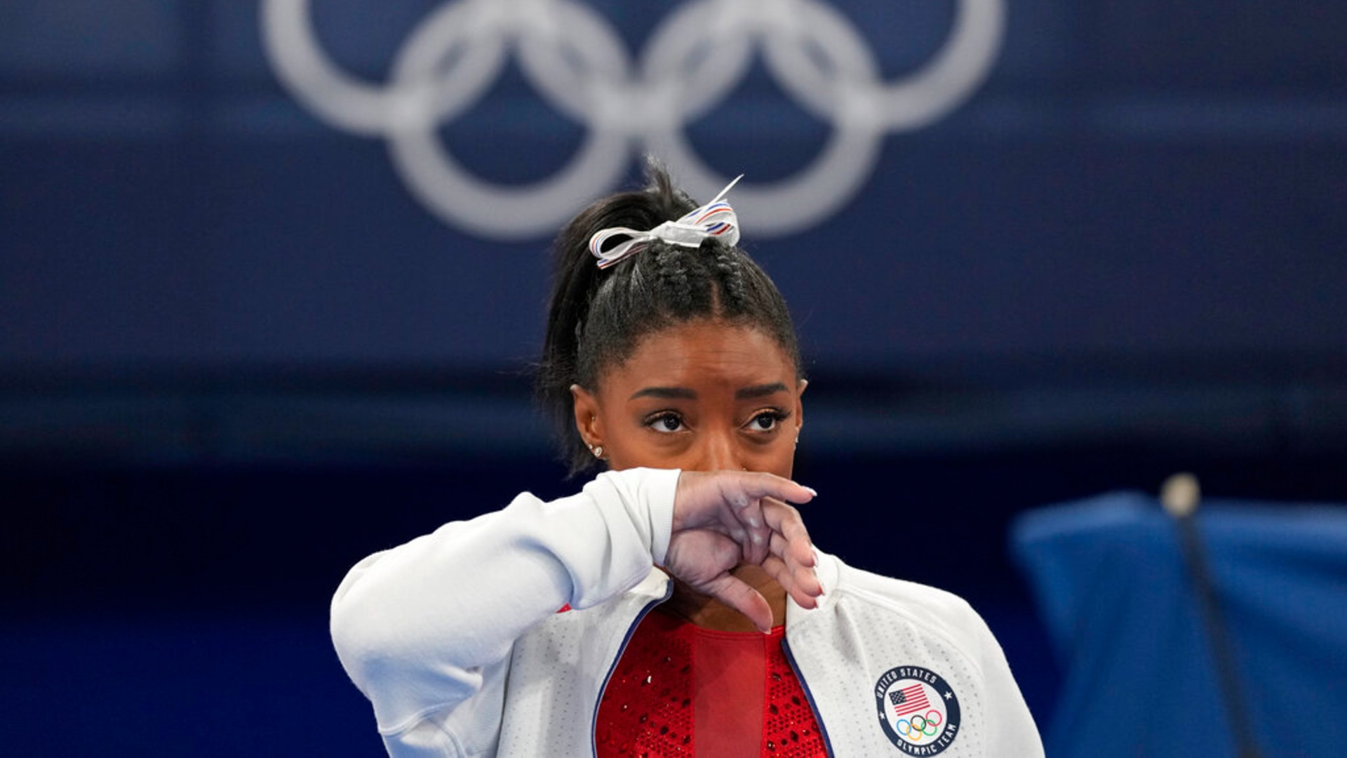 Simone Biles, of the United States, watches gymnasts perform after an apparent injury, at the 2020 Summer Olympics, Tuesday, July 27, 2021, in Tokyo. Biles withdrew from the team finals. (AP Photo/Ashley Landis)