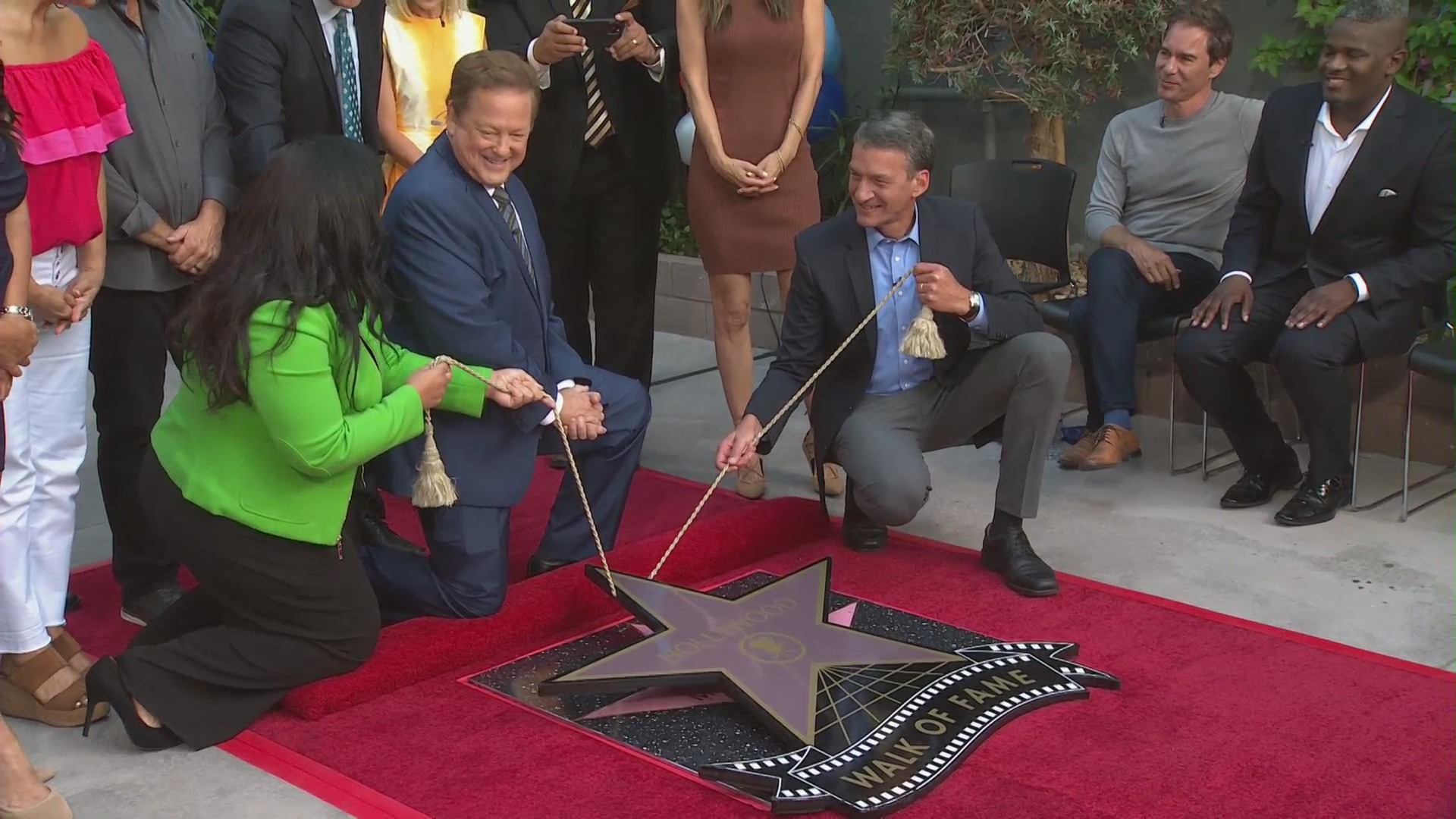 Sam Rubin and Eric Spillman help unveil KTLA's Award of Excellence from the Hollywood Chamber of Commerce on July 8, 2021. (KTLA)