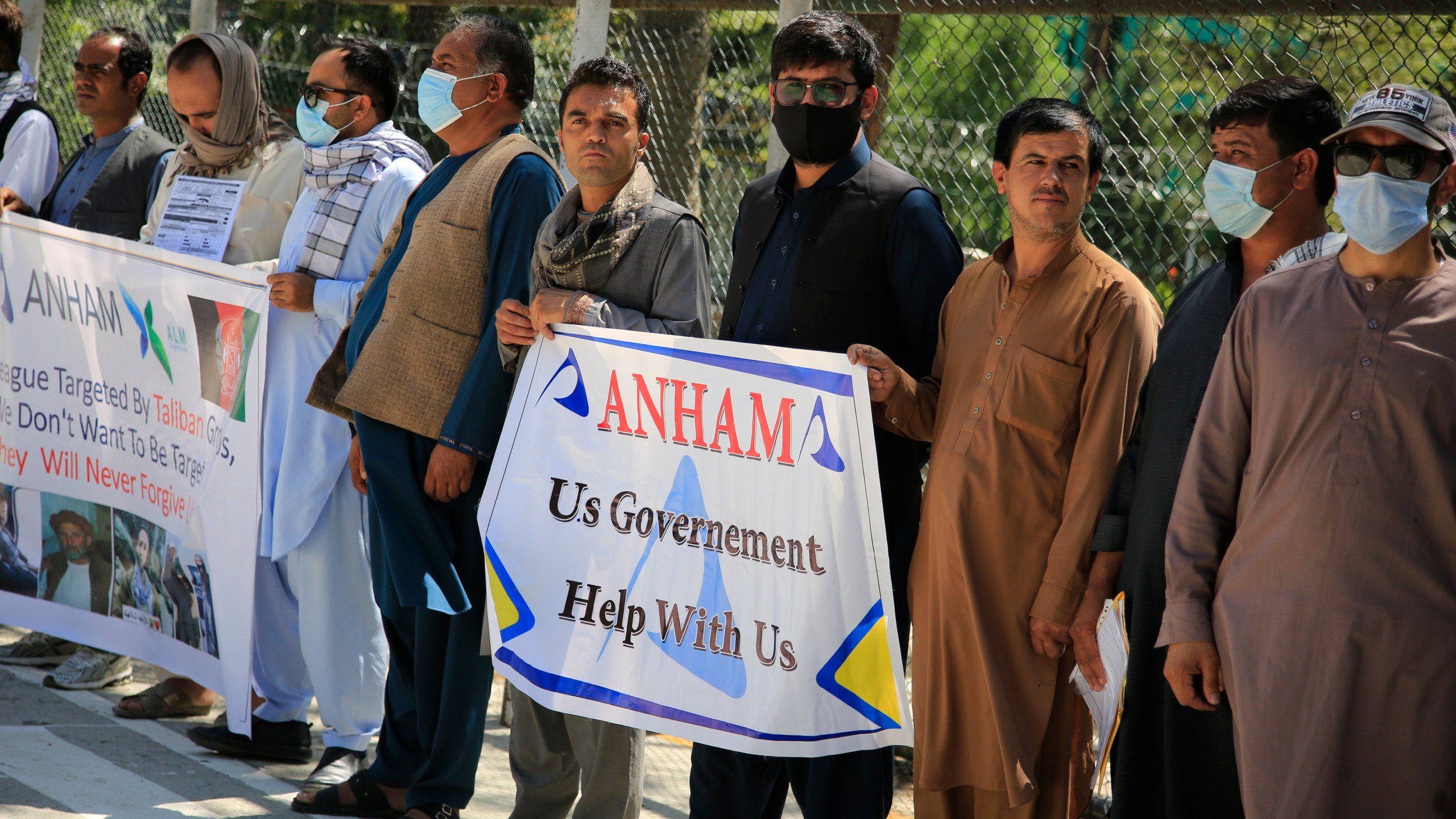 Former workers who had been employed with U.S. troops at the Bagram airbase hold placards during a demonstration against the U.S. government in Kabul, Afghanistan on July, 9, 2021. (Mariam Zuhaib/Associated Press)