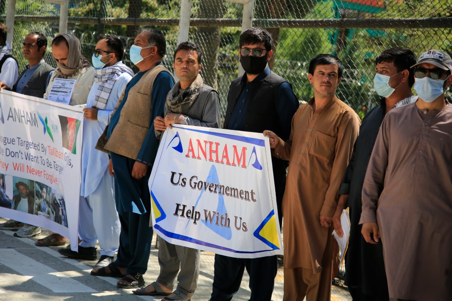 Former workers who had been employed with U.S. troops at the Bagram airbase hold placards during a demonstration against the U.S. government in Kabul, Afghanistan on July, 9, 2021. (Mariam Zuhaib/Associated Press)