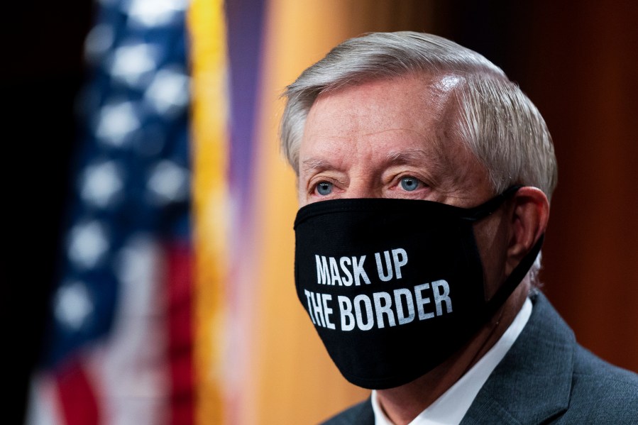 Sen. Lindsey Graham, R-S.C., wearing a mask, takes a pause at the start of a news conference about the United States/Mexico border at the Capitol in Washington, Friday, July 30, 2021. (AP Photo/Manuel Balce Ceneta)