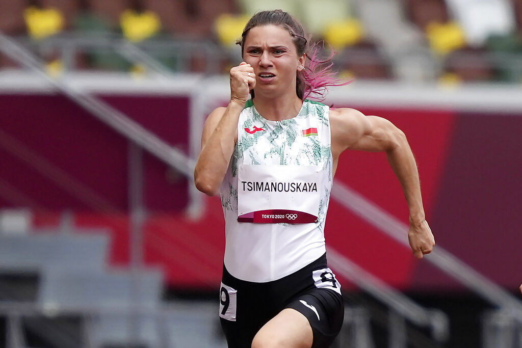 Krystsina Tsimanouskaya, of Belarus, runs in the women's 100-meter run at the 2020 Summer Olympics, Friday, July 30, 2021. (AP Photo/Martin Meissner)