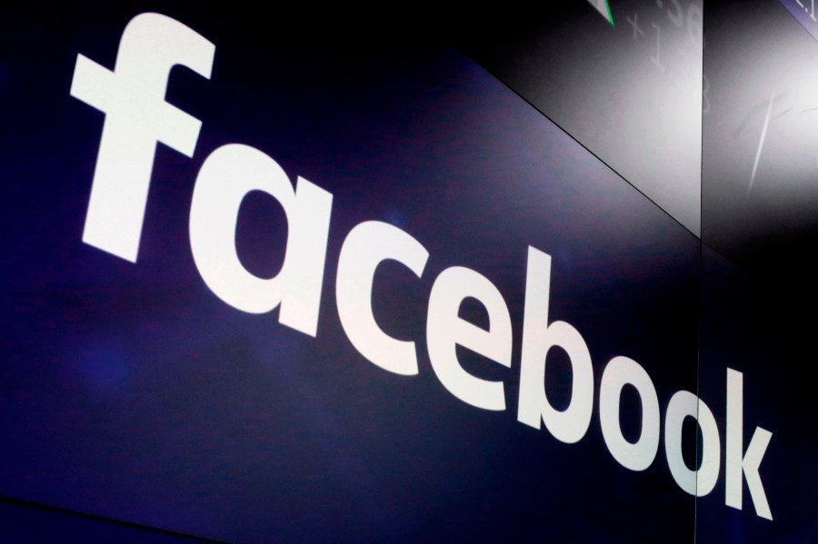 In this March 29, 2018, file photo, the logo for Facebook appears on screens at the Nasdaq MarketSite in New York's Times Square. Facebook has shut down the personal accounts of a pair of New York University researchers and shuttered their investigation into misinformation spread through political ads on the social network. Facebook says the researchers violated its terms of service and were involved in unauthorized data collection from its massive network. The academics, however, say the company is attempting to exert control on research that paints it in a negative light. (AP Photo/Richard Drew, File)