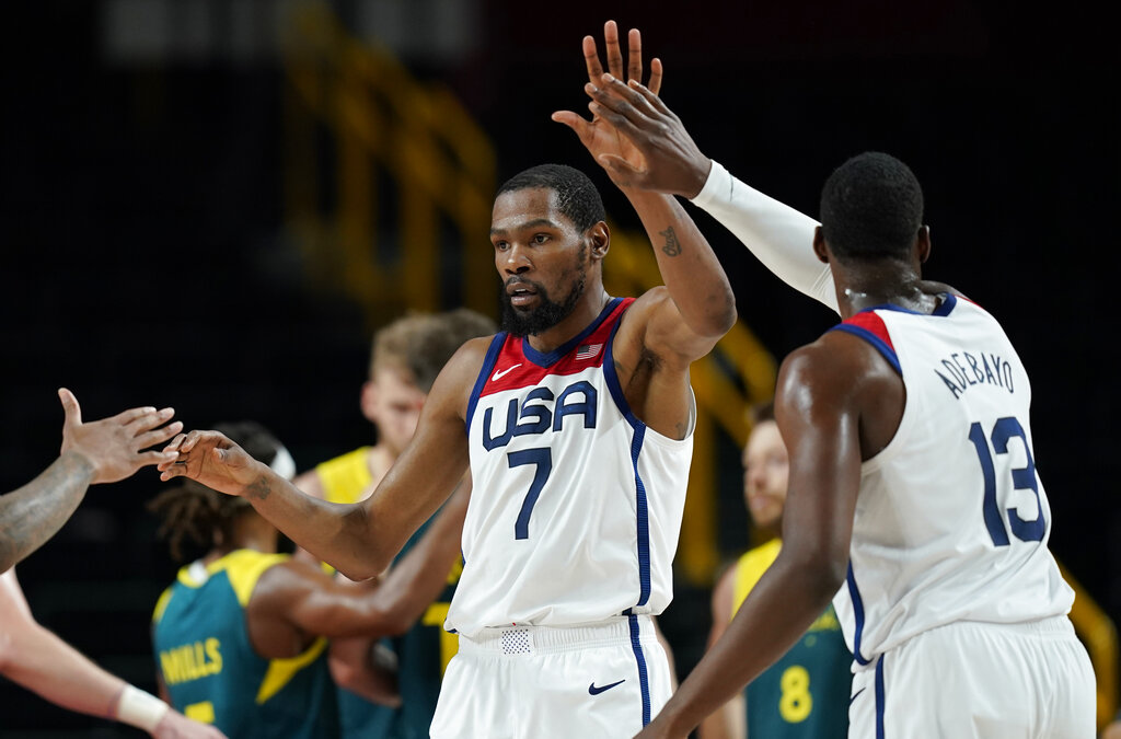 United States's Kevin Durant (7) celebrates with teammates after scoring during men's basketball semifinal game against Australia at the 2020 Summer Olympics, Thursday, Aug. 5, 2021, in Saitama, Japan. (AP Photo/Charlie Neibergall)