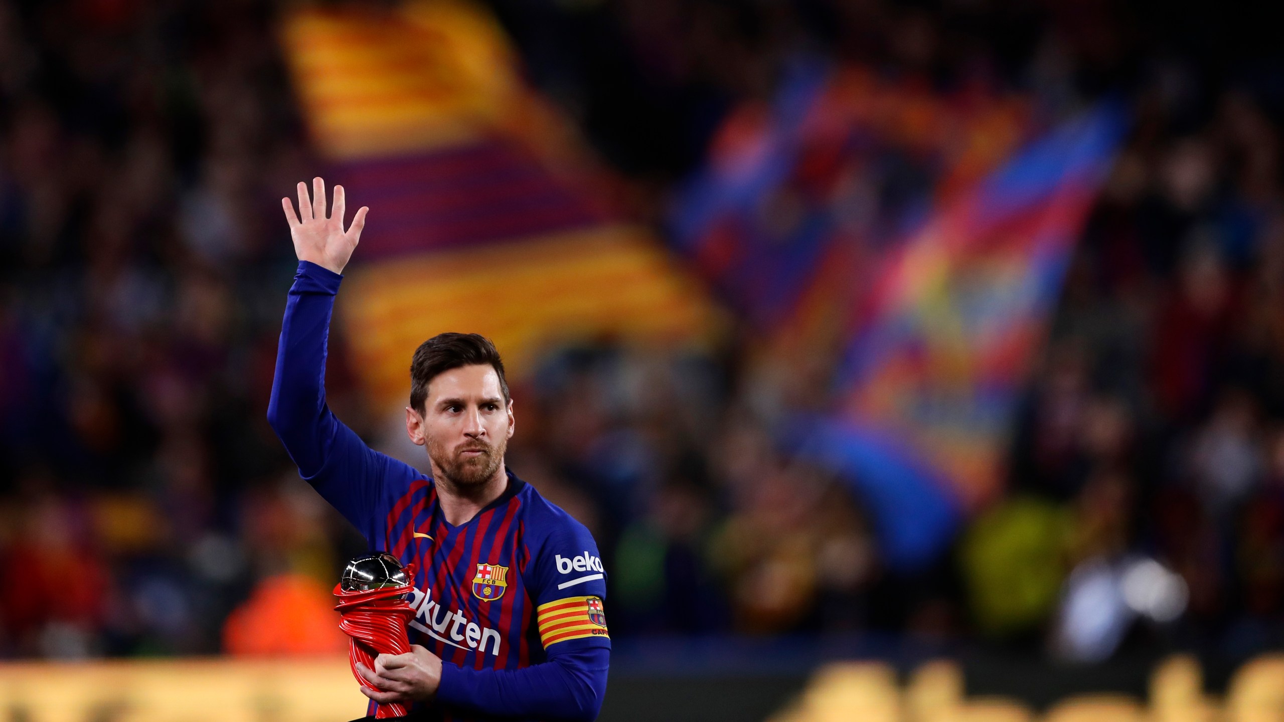 In this April 6, 2019, file photo, Barcelona forward Lionel Messi waves at the crowd as he holds the trophy of the best Spanish La Liga player prior to a soccer match between FC Barcelona and Atletico Madrid at the Camp Nou stadium in Barcelona, Spain. (AP Photo/Manu Fernandez, File)