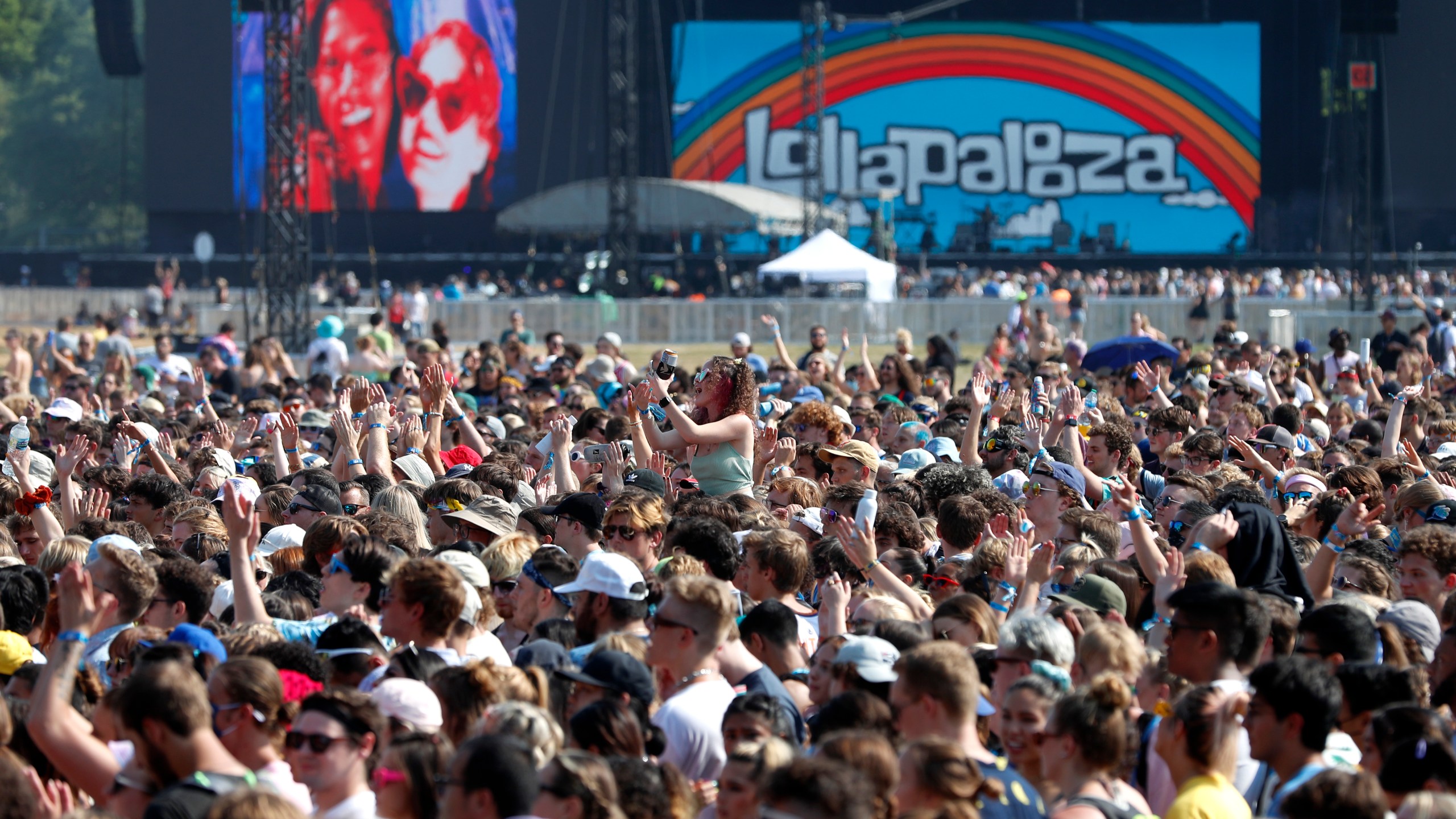 In this July 29, 2021 file photo, fans gather and cheer on day one of the Lollapalooza music festival at Grant Park in Chicago. Chicago health officials on Thursday, Aug. 12, 2021, reported 203 cases of COVID-19 connected to Lollapalooza, casting it as a number that was anticipated and not yet linked to any hospitalizations or deaths. (AP Photo/Shafkat Anowar File)