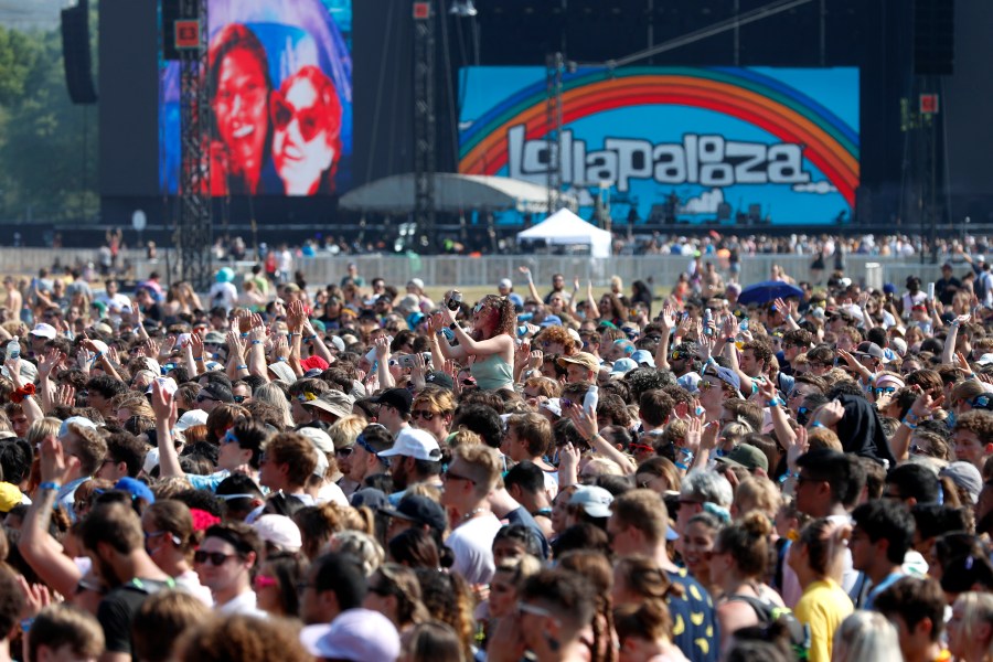 In this July 29, 2021 file photo, fans gather and cheer on day one of the Lollapalooza music festival at Grant Park in Chicago. Chicago health officials on Thursday, Aug. 12, 2021, reported 203 cases of COVID-19 connected to Lollapalooza, casting it as a number that was anticipated and not yet linked to any hospitalizations or deaths. (AP Photo/Shafkat Anowar File)