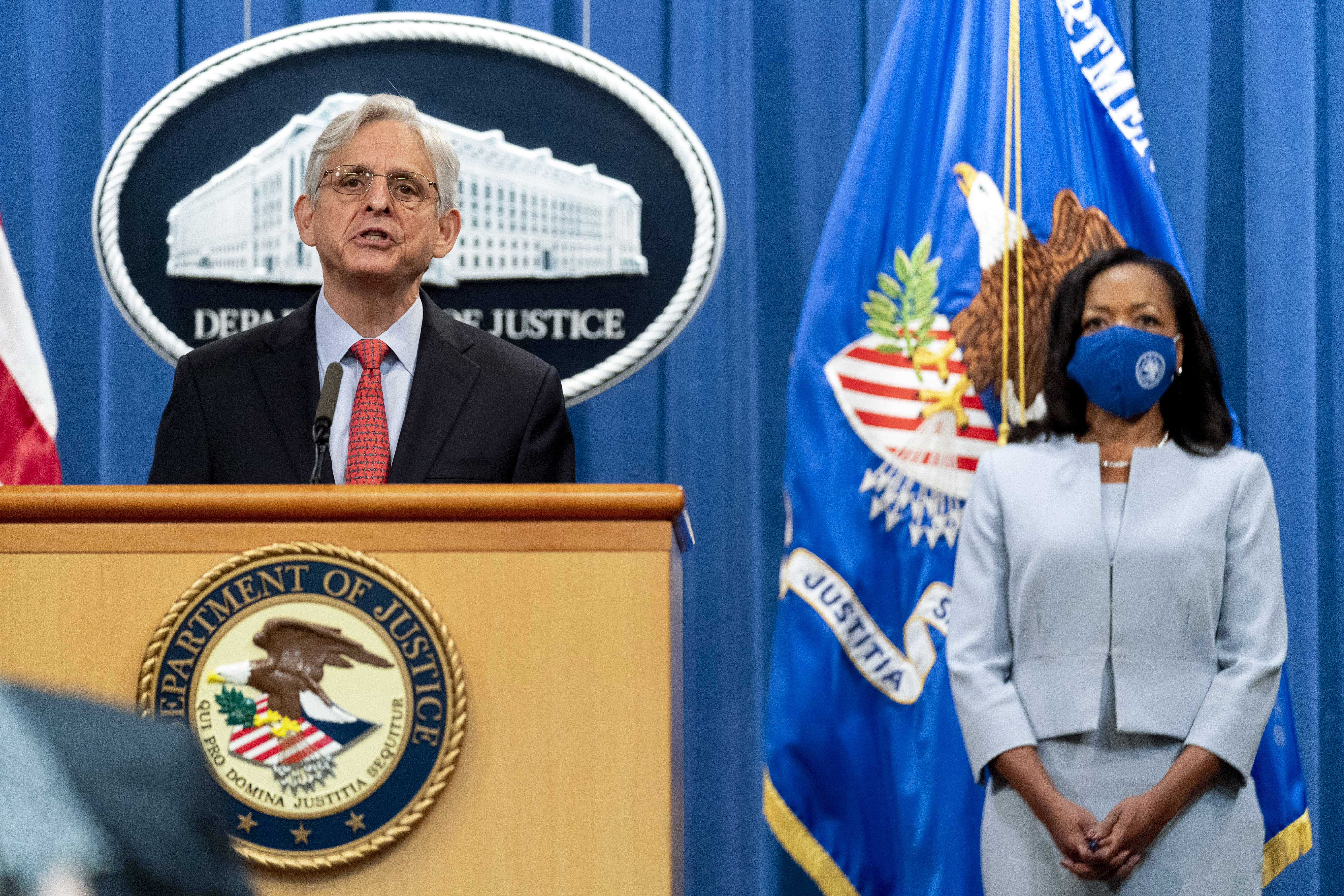 Attorney General Merrick Garland, accompanied by Assistant Attorney General for Civil Rights Kristen Clarke, right, speaks at a news conference at the Department of Justice in Washington on Aug. 5, 2021, to announce that the Department of Justice is opening an investigation into the city of Phoenix and the Phoenix Police Department. (AP Photo/Andrew Harnik)