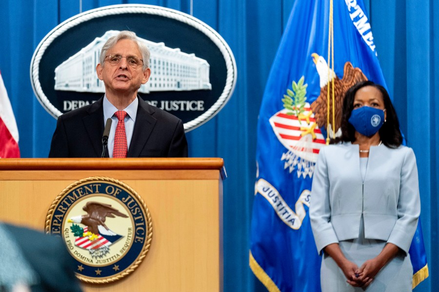 Attorney General Merrick Garland, accompanied by Assistant Attorney General for Civil Rights Kristen Clarke, right, speaks at a news conference at the Department of Justice in Washington on Aug. 5, 2021, to announce that the Department of Justice is opening an investigation into the city of Phoenix and the Phoenix Police Department. (AP Photo/Andrew Harnik)