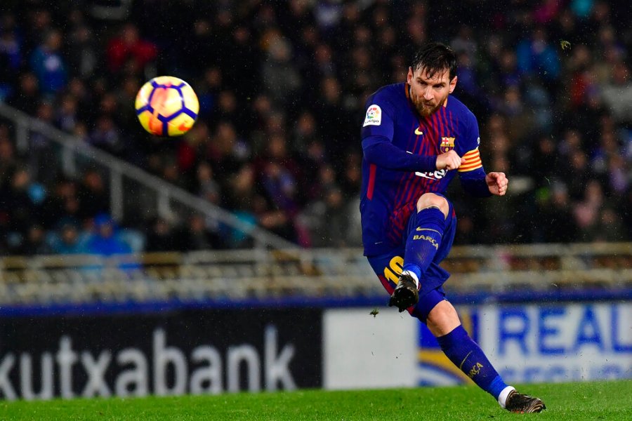 In this Jan.14, 2018 file photo FC Barcelona's Lionel Messi kicks the ball and scores the fourth goal of his team against Real Sociedad at Anoeta stadium, in San Sebastian, northern Spain. (AP Photo/Alvaro Barrientos, File)