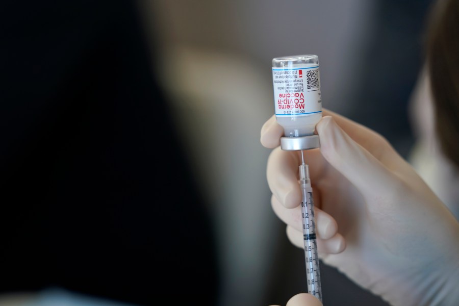 In this March 29, 2021, file photo, a worker readies syringes with the Moderna COVID-19 vaccine in Metairie, La. (AP Photo/Gerald Herbert, File)