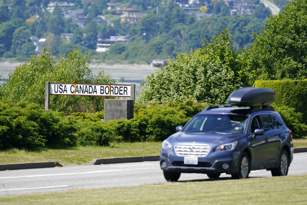 In this June 8, 2021, file photo, a car heads into the U.S. from Canada at the Peace Arch border crossing in Blaine, Wash. (AP Photo/Elaine Thompson, File)