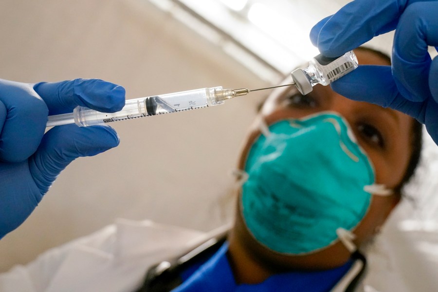 In this Jan. 15, 2021, file photo, Dr. Yomaris Pena, Internal Medicine Physician with Somos Community Care at a COVID-19 extracts the last bit of Pfizer-BioNTech COVID-19 Vaccine out of a vial so as not to waste it at a vaccination site at the Corsi Houses in the East Harlem neighborhood of New York. (AP Photo/Mary Altaffer, File)