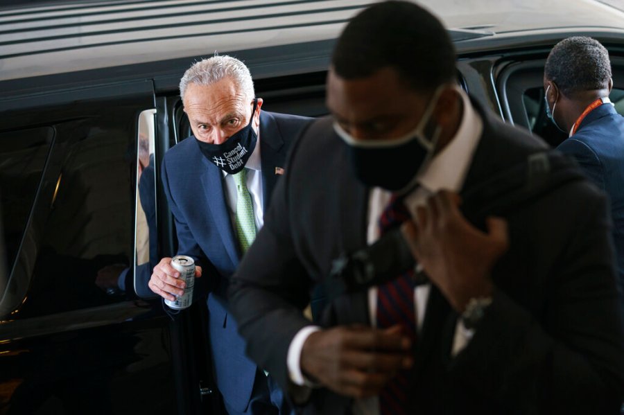 Senate Majority Leader Chuck Schumer, D-N.Y., arrives with his security detail as senators convene for a rare weekend session to continue work on the $1 trillion bipartisan infrastructure bill, at the Capitol in Washington, Sunday, Aug. 8, 2021. (AP Photo/J. Scott Applewhite)