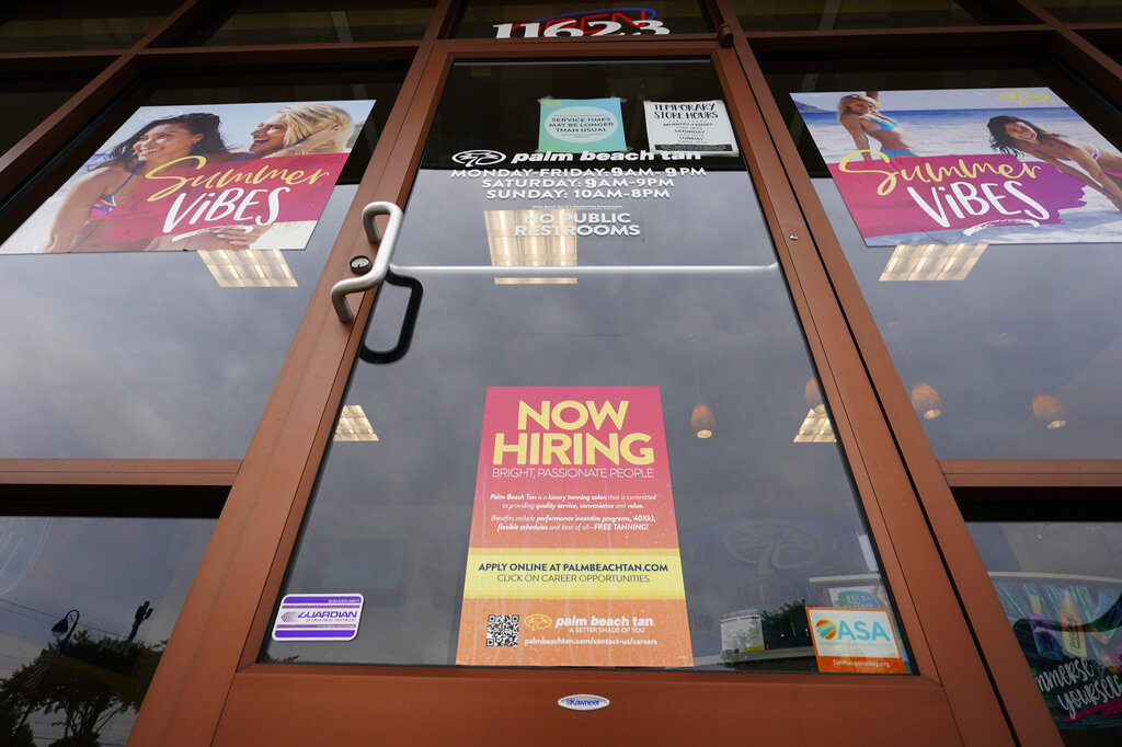 A Now Hiring sign at a business in Richmond, Va., Wednesday, June 2, 2021. (AP Photo/Steve Helber)