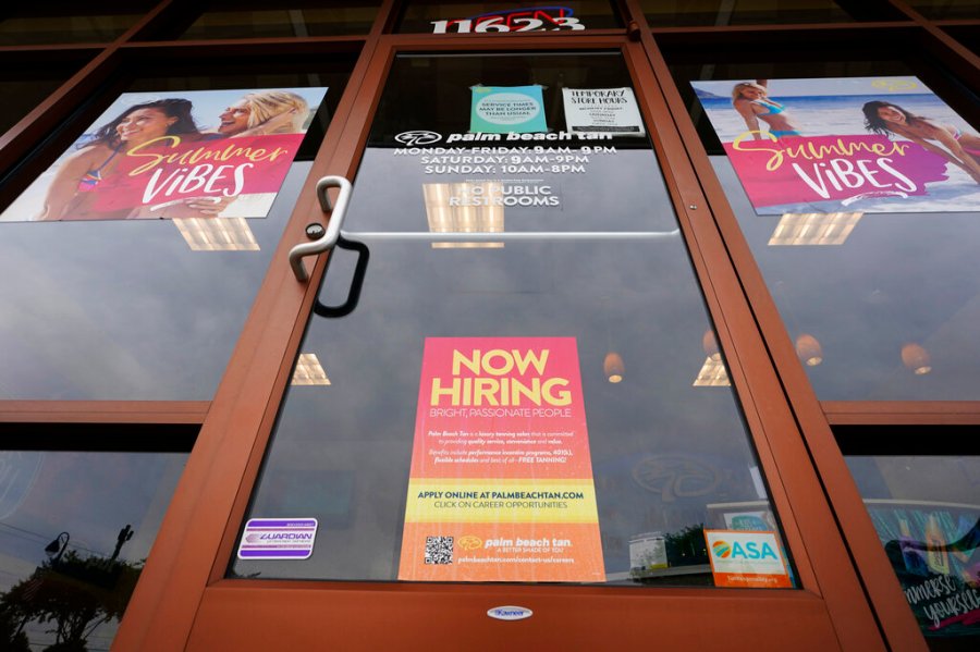 A Now Hiring sign at a business in Richmond, Va., Wednesday, June 2, 2021. (AP Photo/Steve Helber)