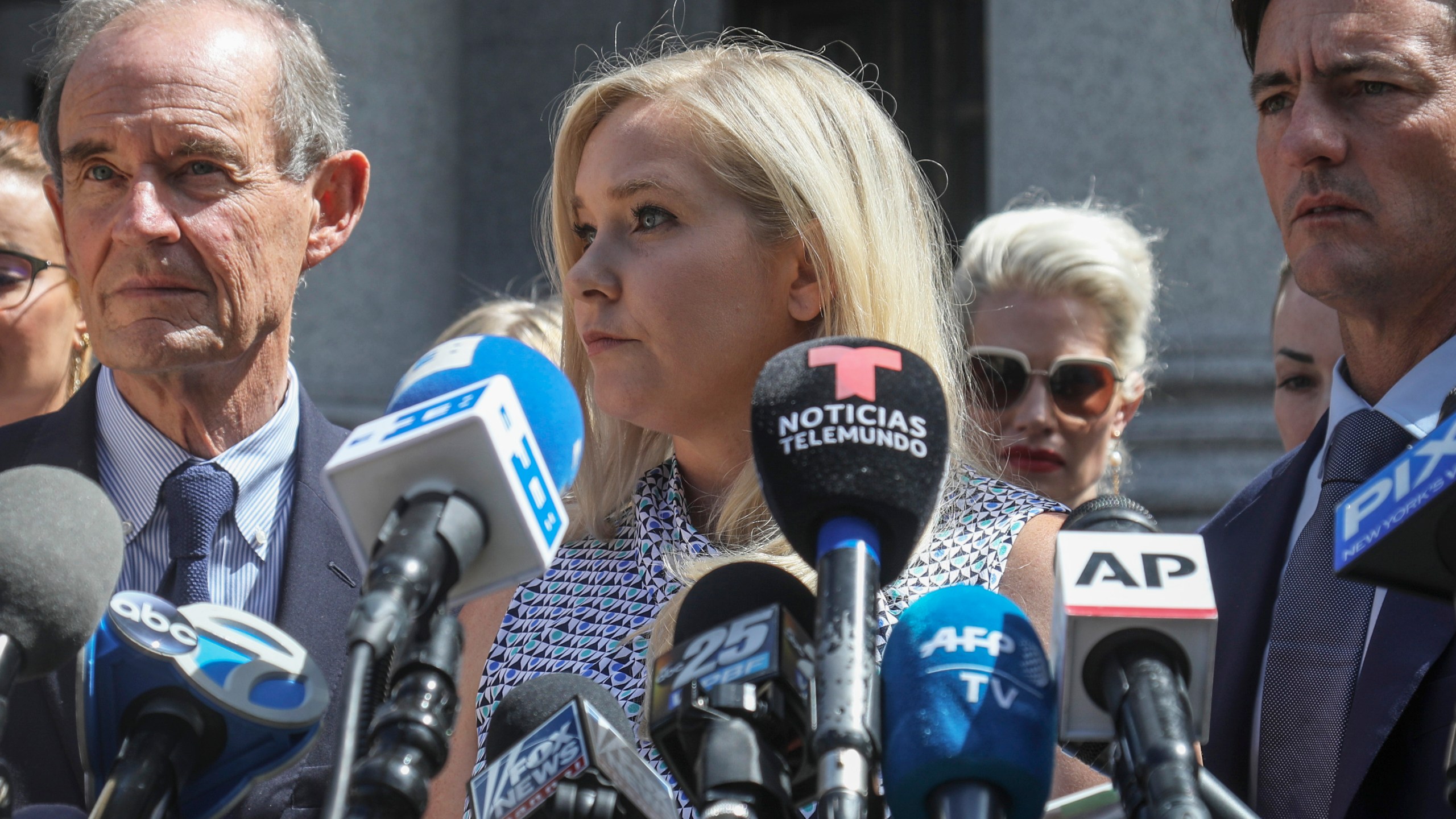 In this Aug. 27, 2019 file photo, Virginia Giuffre, center, who says she was trafficked by sex offender Jeffrey Epstein, holds a news conference outside a Manhattan court in New York. (Bebeto Matthews/AssociatedPress)