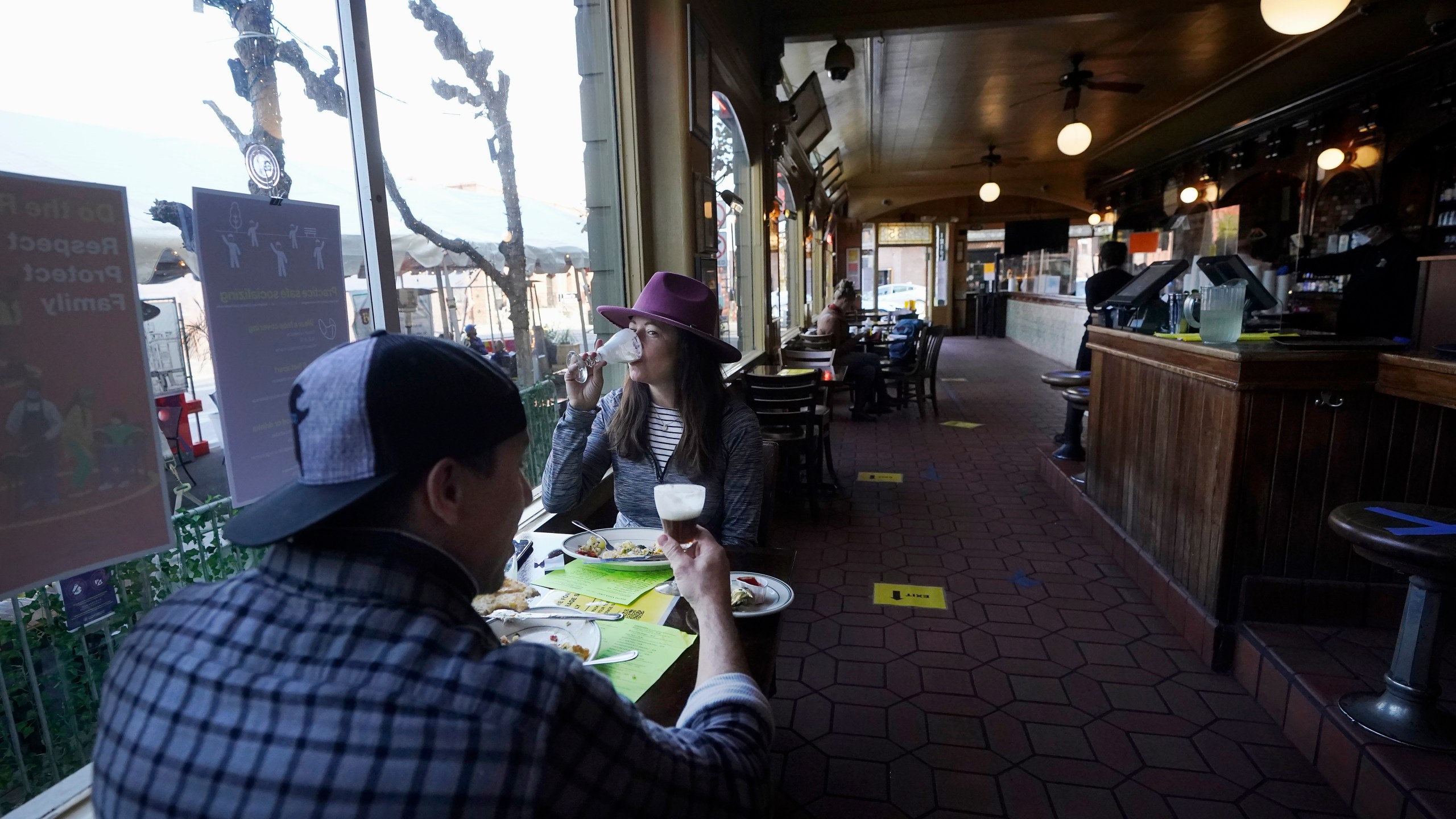 In this Nov. 12, 2020, file photo, diners Mitchell Bryant, left, and Darla Scott eat inside at the Buena Vista Cafe amid the coronavirus outbreak in San Francisco. San Francisco will require proof of full vaccination against COVID-19 for a number of indoor activities such as visiting restaurants, bars and gyms. A city supervisor confirmed the new mandate shortly before Mayor London Breed was scheduled to hold a news conference Thursday, Aug. 12, 2021.(AP Photo/Jeff Chiu, File)