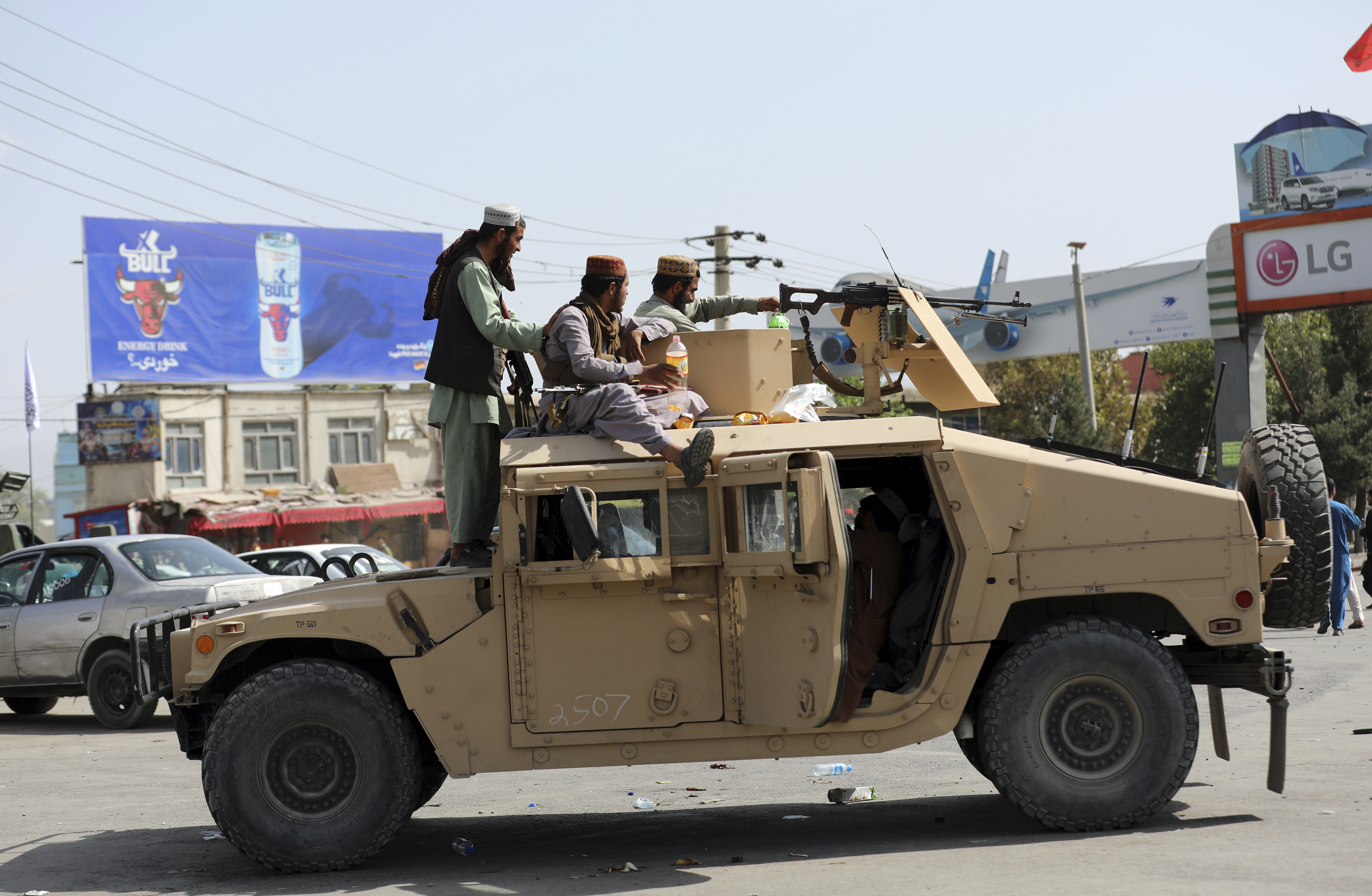 Taliban fighters stand guard in front of the Hamid Karzai International Airport, in Kabul, Afghanistan on Aug. 16, 2021. (Rahmat Gul / Associated Press)