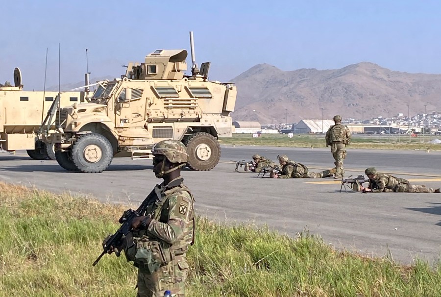 U.S soldiers stand guard along a perimeter at the international airport in Kabul, Afghanistan, Monday, Aug. 16, 2021. On Monday, the U.S. military and officials focus was on Kabul's airport, where thousands of Afghans trapped by the sudden Taliban takeover rushed the tarmac and clung to U.S. military planes deployed to fly out staffers of the U.S. Embassy, which shut down Sunday, and others. (AP Photo/Shekib Rahmani)