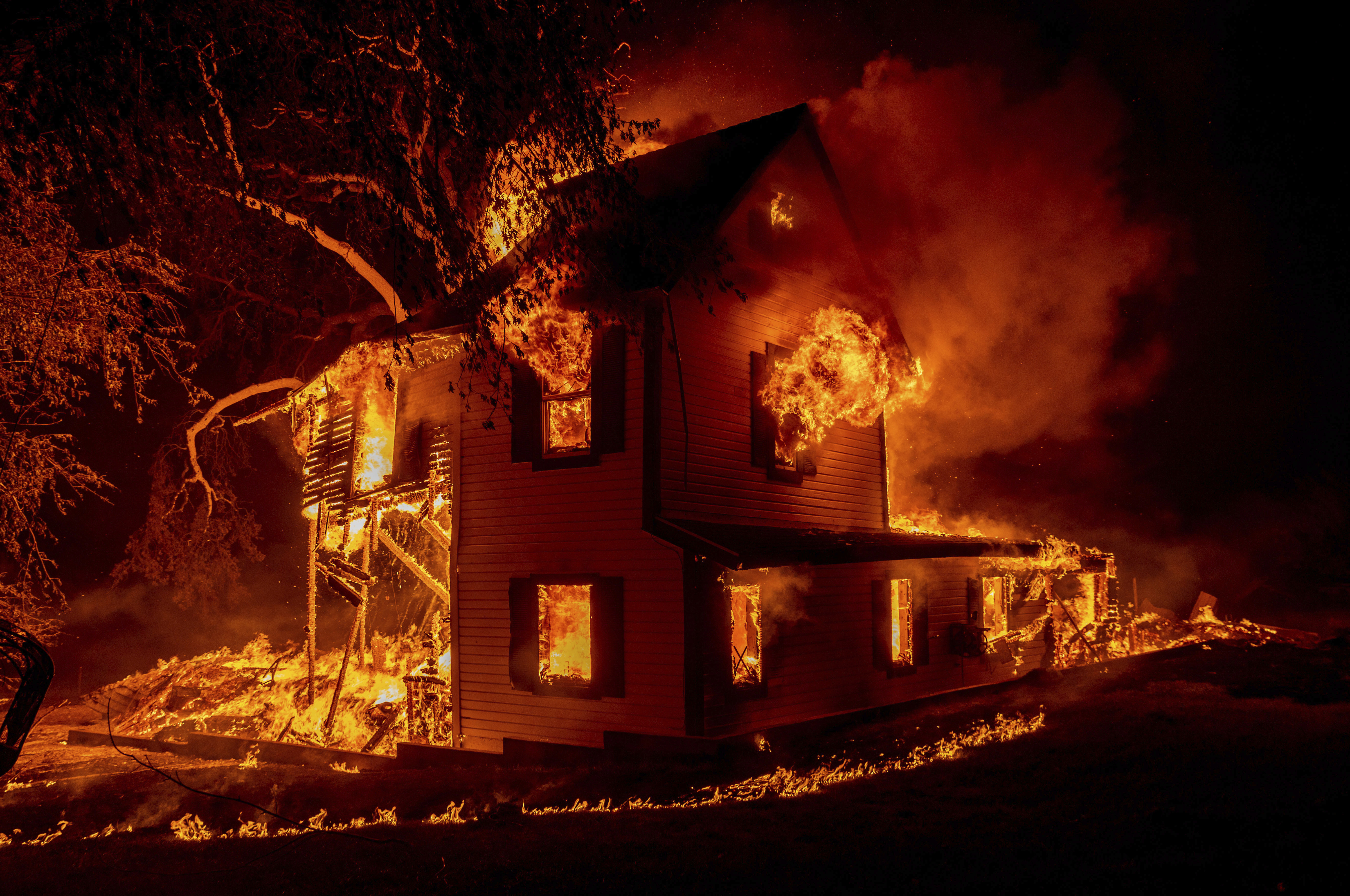 A home burns on Jeters Road as the Dixie Fire jumps Highway 395 south of Janesville, Calif., on Aug. 16, 2021. (Ethan Swope / Associated Press)