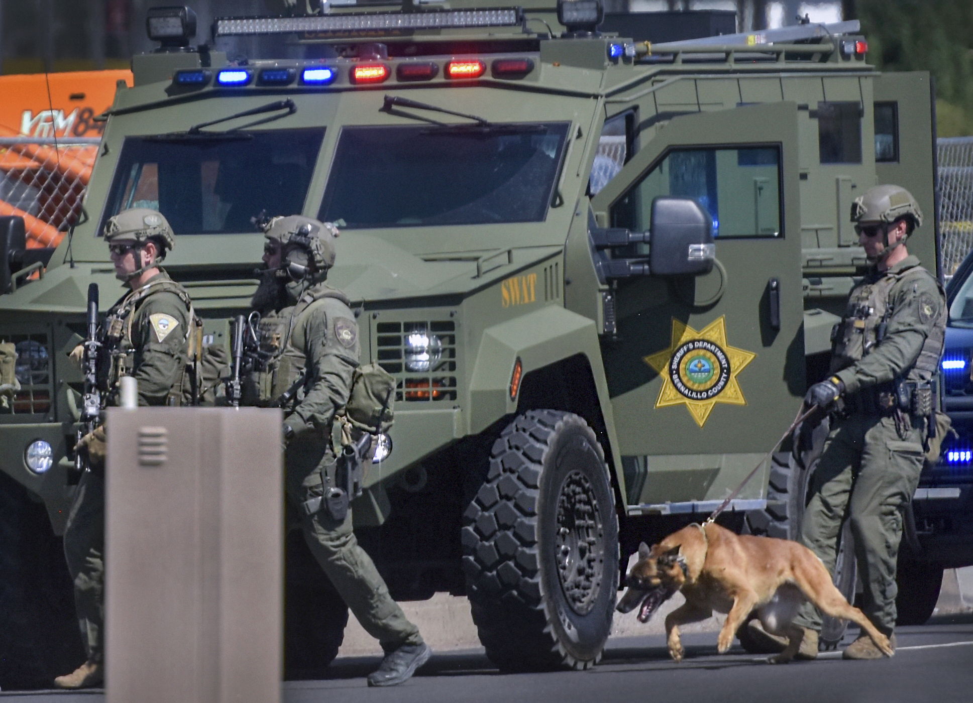 Tactical officers search for a suspect after a shootout that left multiple officers injured in northeast Albuquerque, N.M. on Thursday, Aug. 19, 2021. (Robert Browman/The Albuquerque Journal via AP)