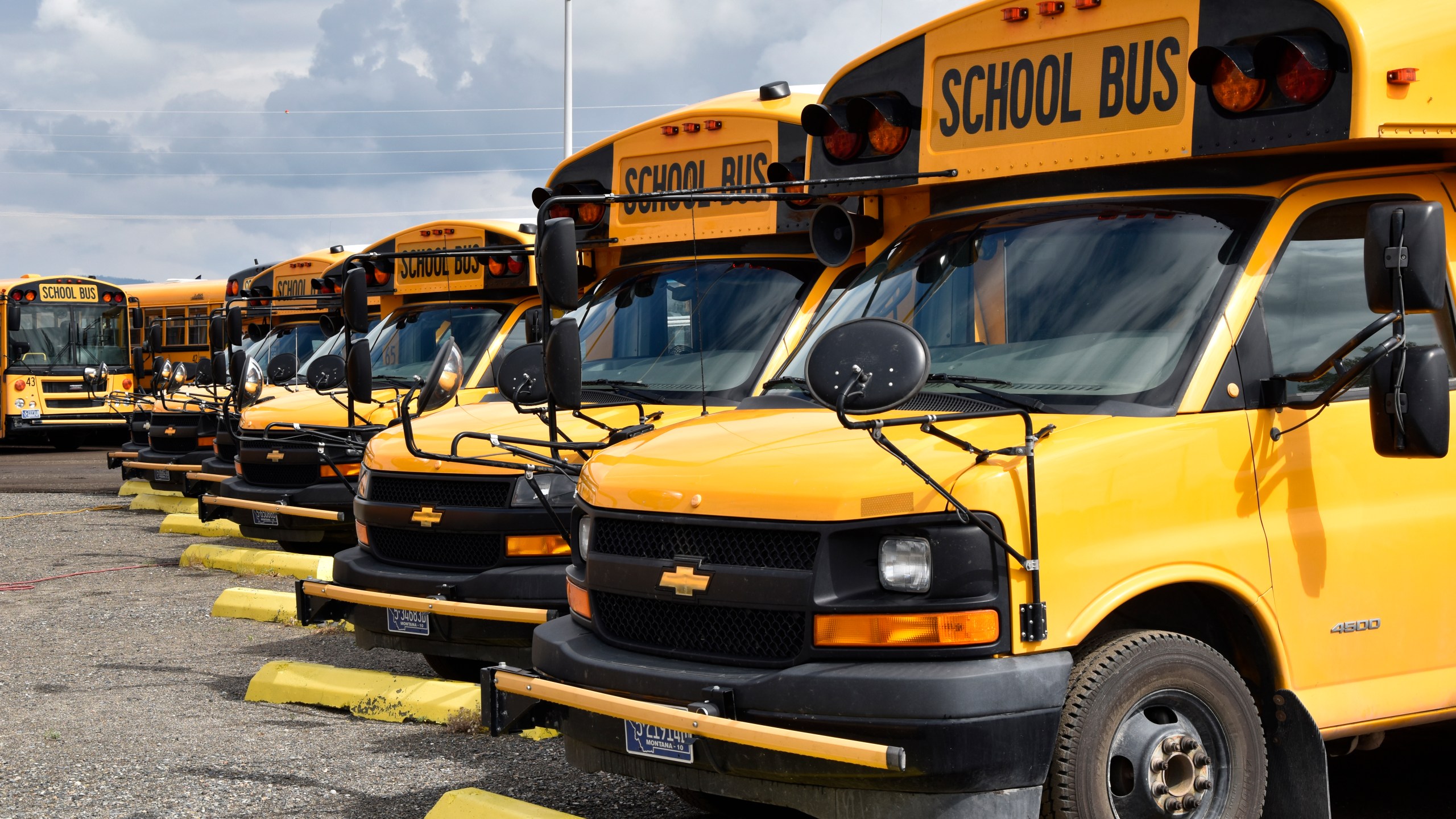 School buses parked in Helena, Mont., ahead of the beginning of the school year, Friday, Aug. 20, 2021. School districts across the country are coping with a shortage of bus drivers, a dilemma that comes even as they struggle to start a new school year during a new surge of the coronavirus pandemic. (AP Photo/Iris Samuels)