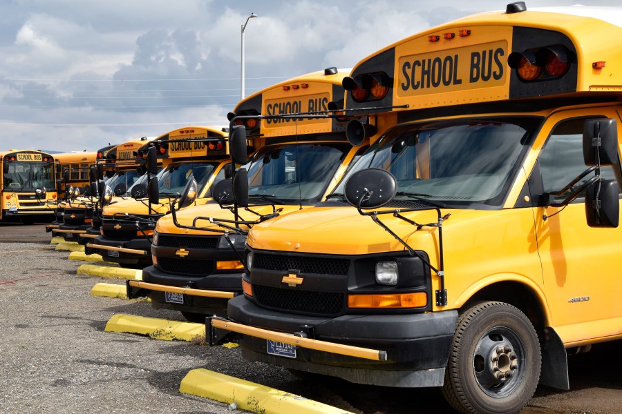 School buses parked in Helena, Mont., ahead of the beginning of the school year, Friday, Aug. 20, 2021. School districts across the country are coping with a shortage of bus drivers, a dilemma that comes even as they struggle to start a new school year during a new surge of the coronavirus pandemic. (AP Photo/Iris Samuels)