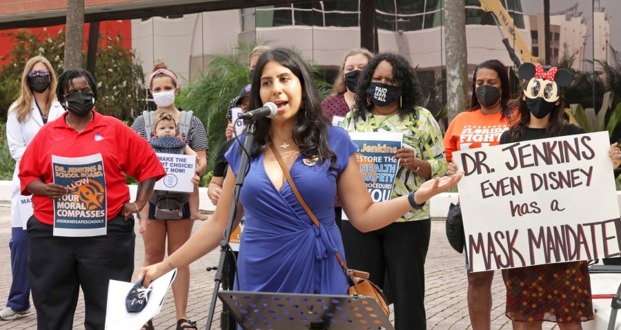 State Rep. Anna Eskamani, D-Orlando, delivers remarks at a protest in front of the Orange County Public Schools headquarters in downtown Orlando, Fla., Monday, Aug. 23, 2021. Teachers, parents and union representatives gathered to demand that the Orange school board adopt a mandatory mask policy because of rising COVID-19 cases, despite an executive order banning school mandates from Florida Gov. Ron DeSantis. (Joe Burbank/Orlando Sentinel via AP)