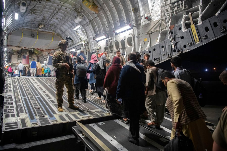 In this Aug. 22, 2021, photo provided by the U.S. Air Force, Afghan passengers board a U.S. Air Force C-17 Globemaster III during the Afghanistan evacuation at Hamid Karzai International Airport in Kabul, Afghanistan. (MSgt. Donald R. Allen/U.S. Air Force via AP)