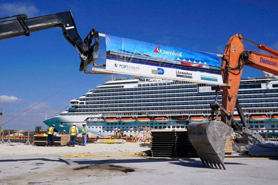 In this Friday, Jan. 29, 2021 photo, The Carnival Dream cruise ship arrives as construction work is underway for Carnival Cruise Line's new Terminal F, which will be the homeport to the Carnival Celebration cruise ship at PortMiami, in Miami. (AP Photo/Lynne Sladky)