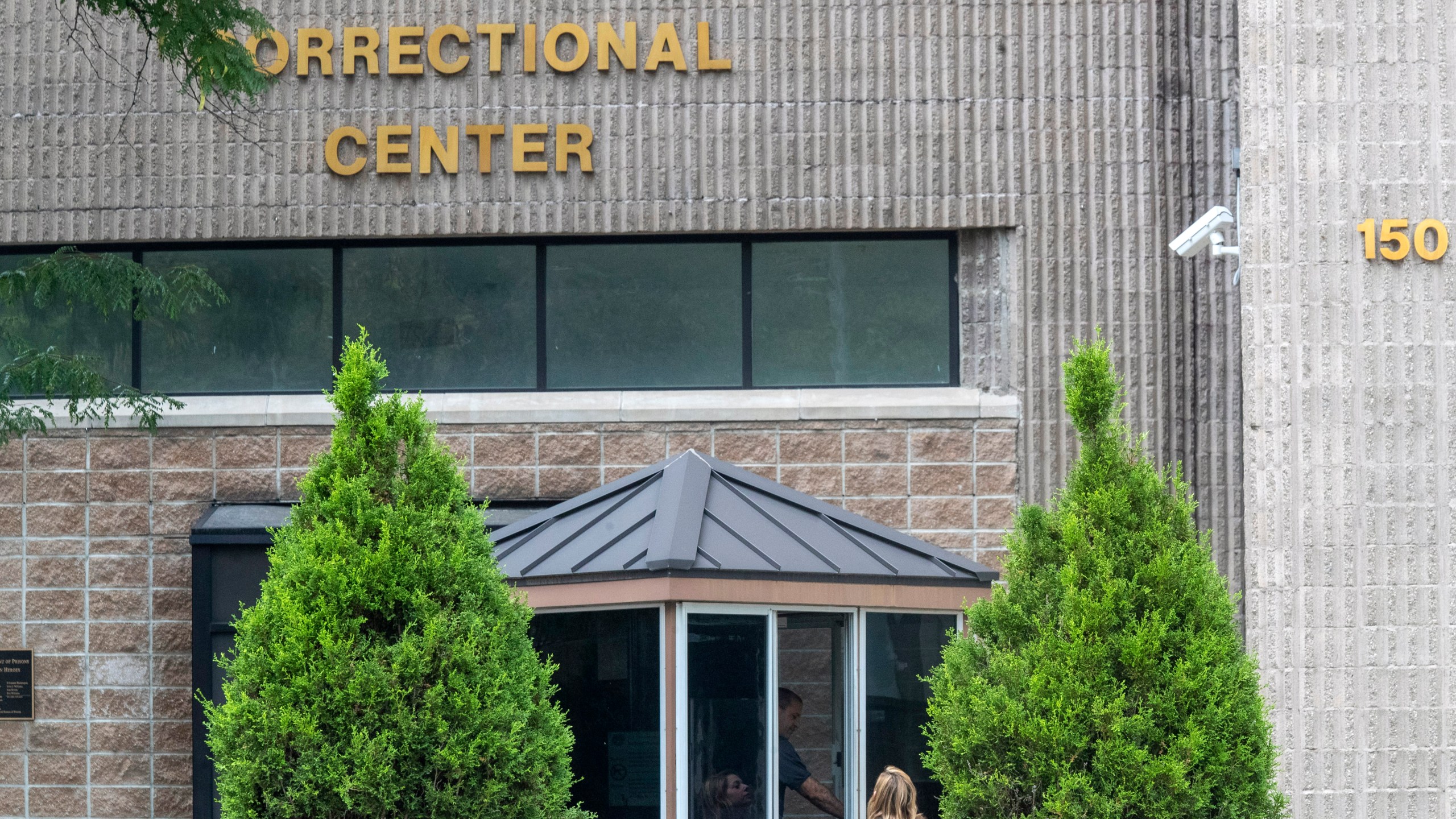 In this Aug. 13, 2019 file photo, an employee checks a visitor outside the Metropolitan Correctional Center in New York. (Mary Altaffer/Associated Press)