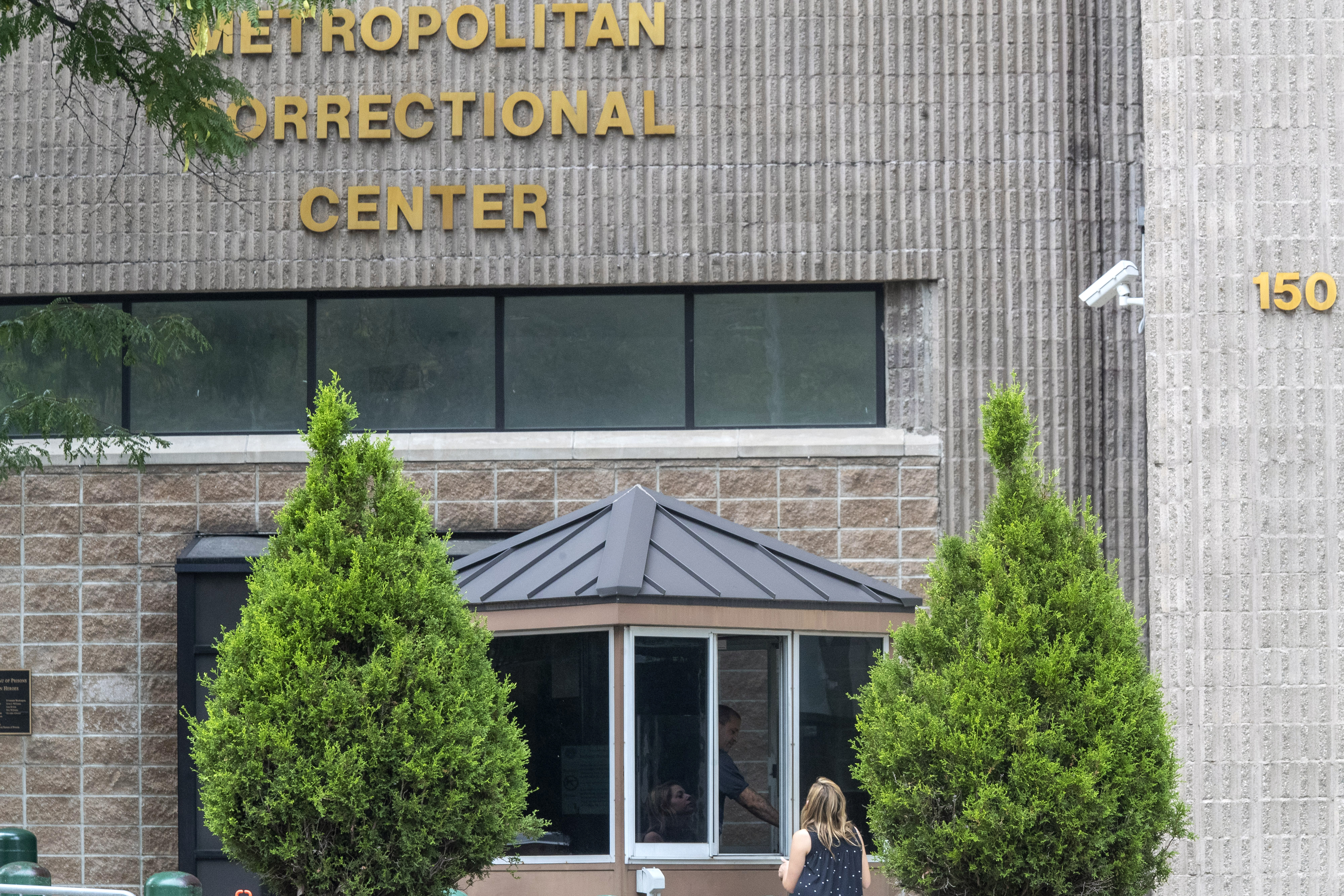 In this Aug. 13, 2019 file photo, an employee checks a visitor outside the Metropolitan Correctional Center in New York. (Mary Altaffer/Associated Press)