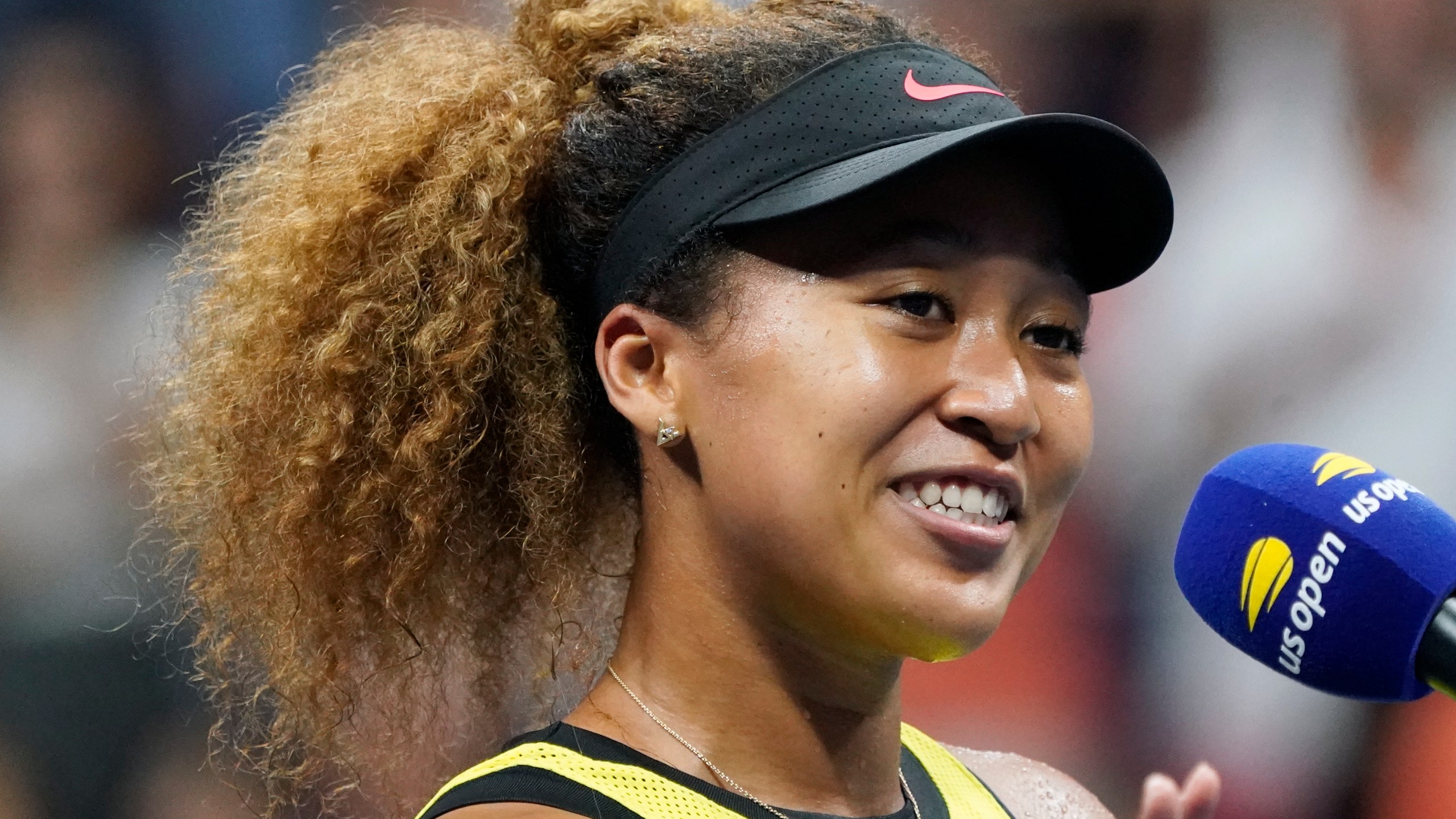 Naomi Osaka speaks to the crowd after beating Marie Bouzkova during the first round of the US Open tennis championships on Aug. 30, 2021, in New York. (AP Photo/Elise Amendola)