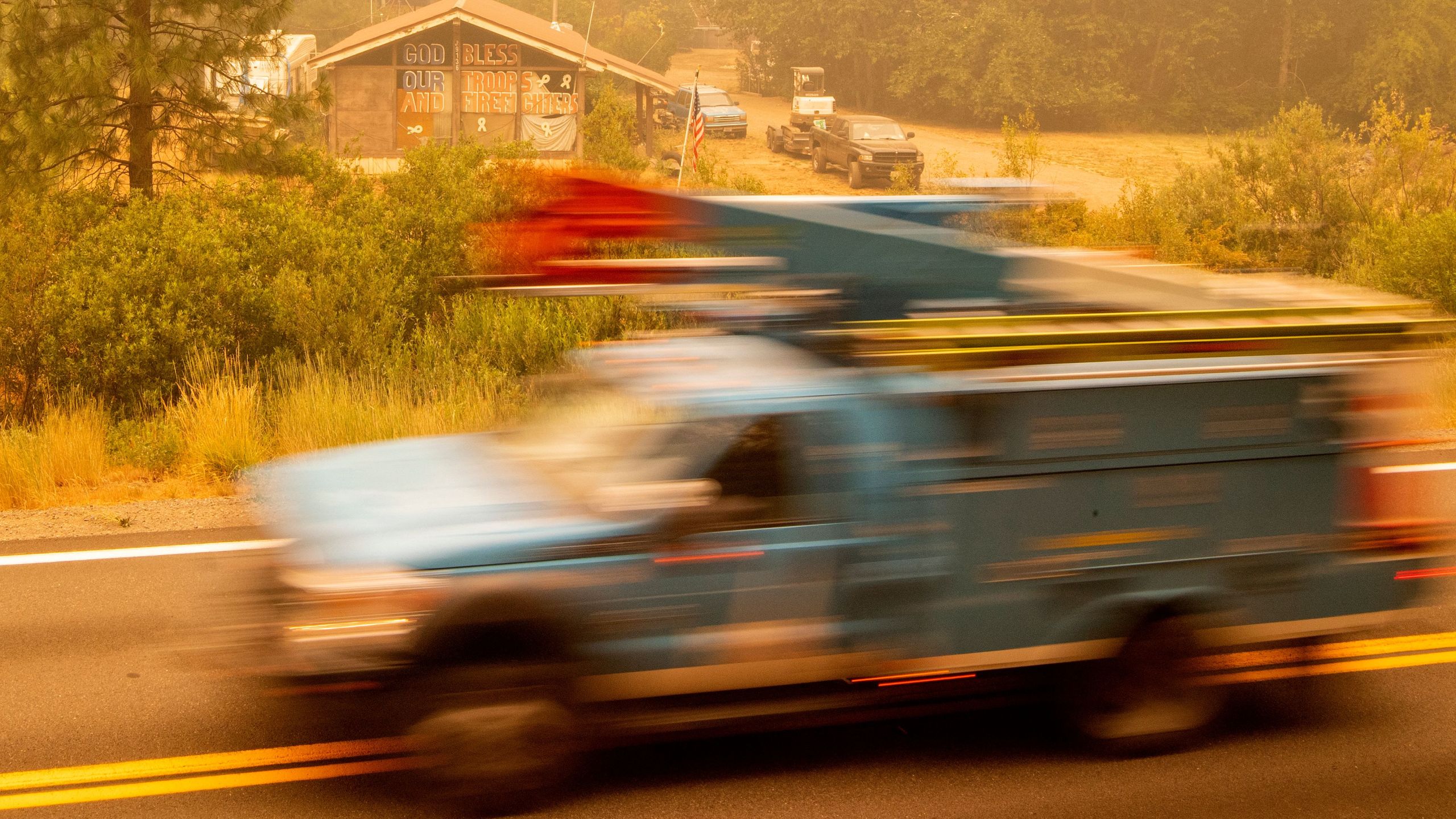 A PG&E truck passes by a home with a message to firefighters during the Dixie Fire near Quincy on July 26, 2021. (JOSH EDELSON/AFP via Getty Images)