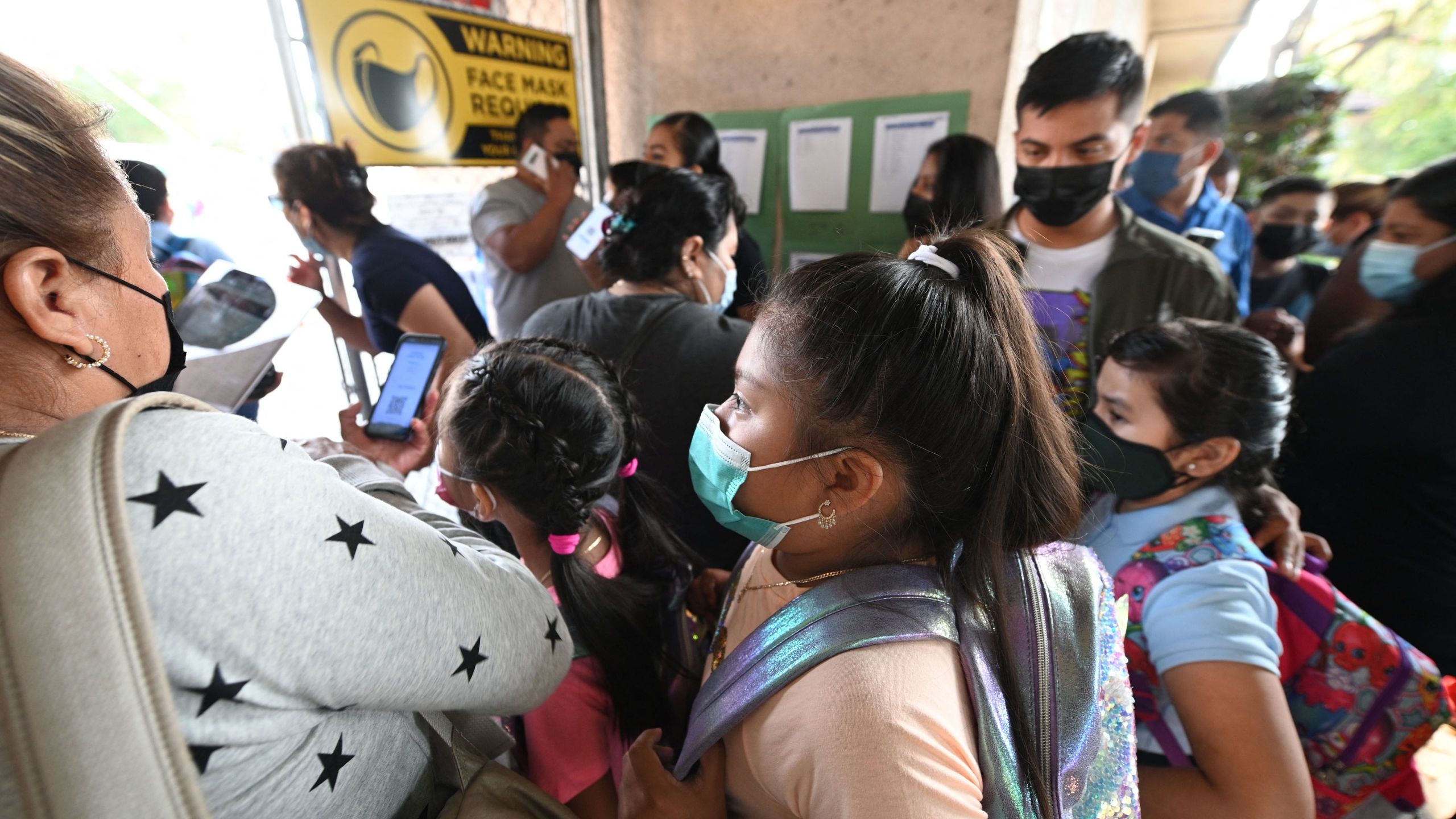 Students and parents arrive masked for the first day of the school year at Grant Elementary School in Los Angeles, California, on Aug. 16, 2021. (ROBYN BECK/AFP via Getty Images)