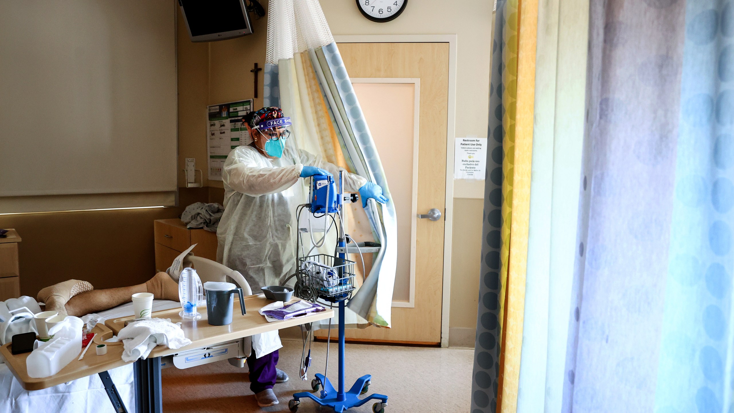 Certified Nursing Assistant (CNA) Paulette Santillan departs after checking a COVID-19 patient's vital signs in the improvised COVID-19 unit at Providence Holy Cross Medical Center in the Mission Hills neighborhood on July 30, 2021 in Los Angeles, California. (Mario Tama/Getty Images)