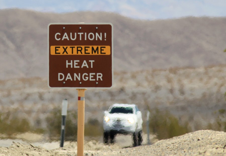 Heat waves rise near a heat danger warning sign on the eve of the AdventurCORPS Badwater 135 ultra-marathon race on July 14, 2013 in Death Valley National Park, California. (David McNew/Getty Images)