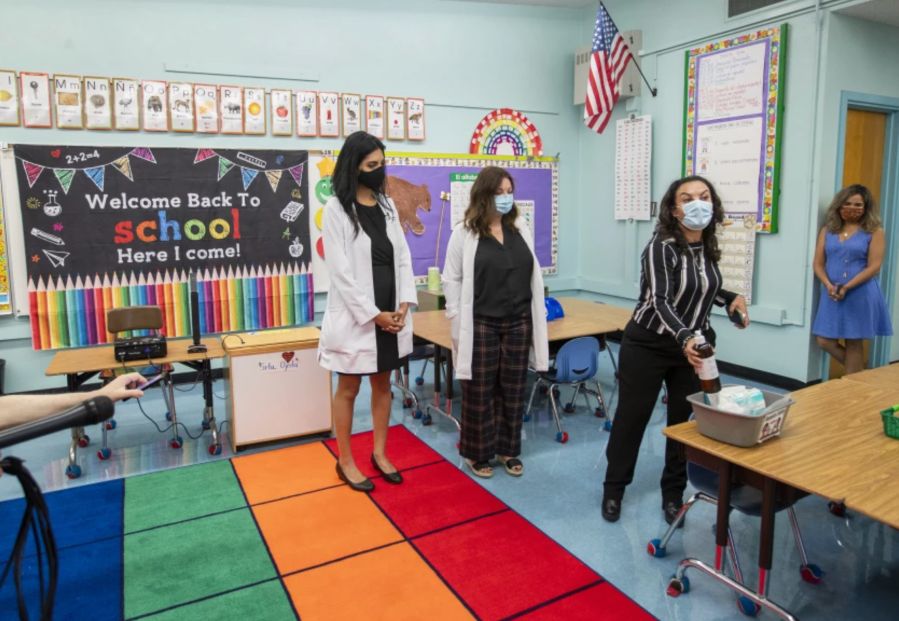 Dr. Smita Malhotra, left, Dr. Rosina Franco and Principal Josefina Flores go over COVID-19 safety measures at Euclid Avenue Elementary School in Boyle Heights in late July, 2021.(Allen J. Schaben / Los Angeles Times)