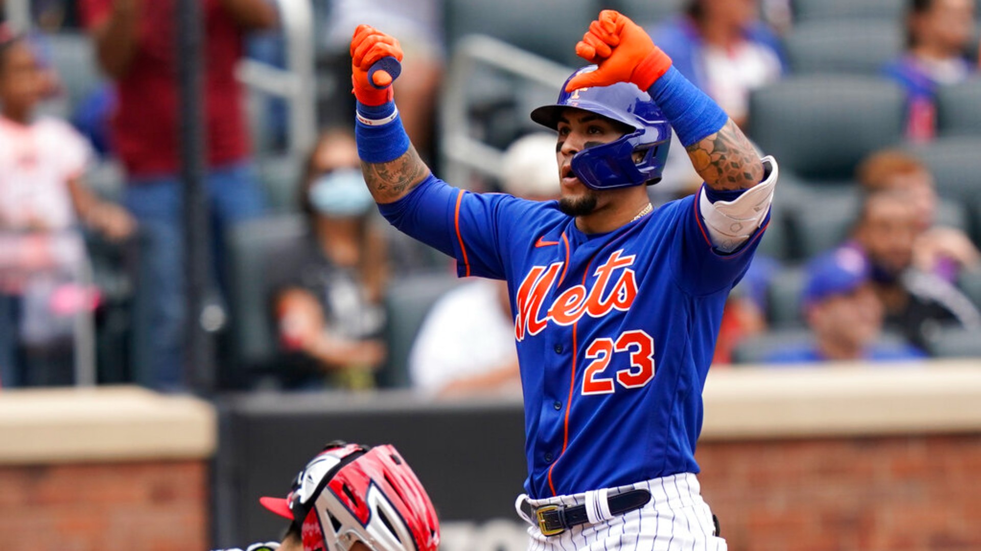 New York Mets' Javier Baez gestures at home plate after his two-run home run that also scored Michael Conforto during the fourth inning of a baseball game against the Washington Nationals, Sunday, Aug. 29, 2021, in New York. (AP Photo/Corey Sipkin)