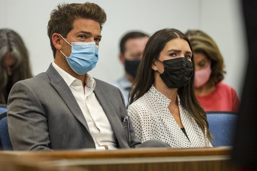 Newport Beach Dr. Grant Robicheaux, and his girlfriend, Cerissa Riley, sit inside a courtroom during a hearing at Orange County Superior Court in Santa Ana on Aug. 19, 2021. (Irfan Khan / Los Angeles Times)