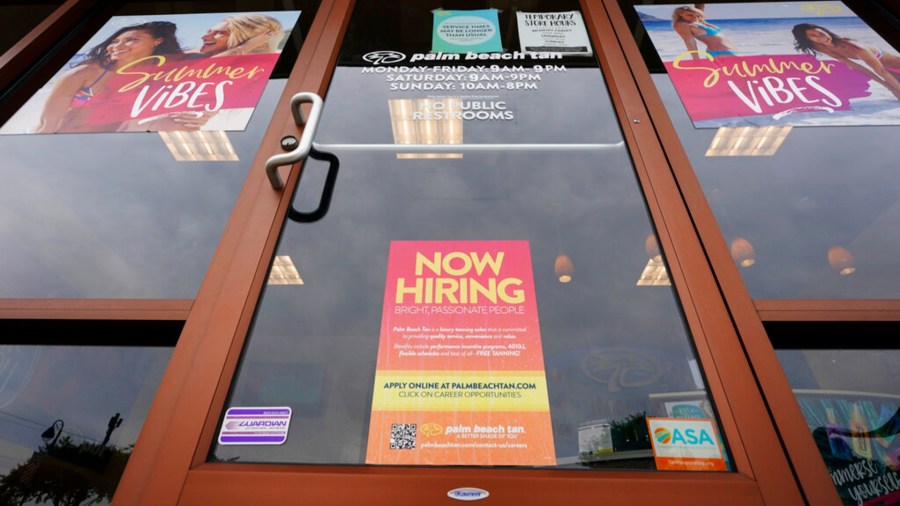 A Now Hiring sign at a business in Richmond, Va., Wednesday, June 2, 2021. (AP Photo/Steve Helber)