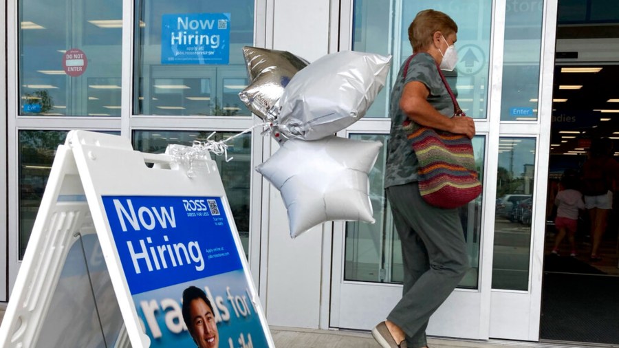 A shopper passes a hiring sign while entering a retail store in Morton Grove, Ill., Wednesday, July 21, 2021. (AP Photo/Nam Y. Huh)