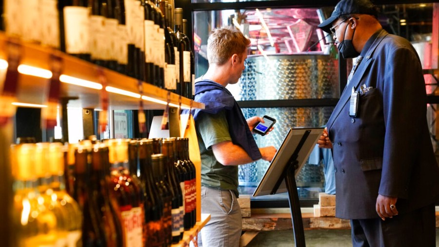 Security personnel ask customers for proof of vaccination as they enter City Winery Thursday, June 24, 2021, in New York. (AP Photo/Frank Franklin II)