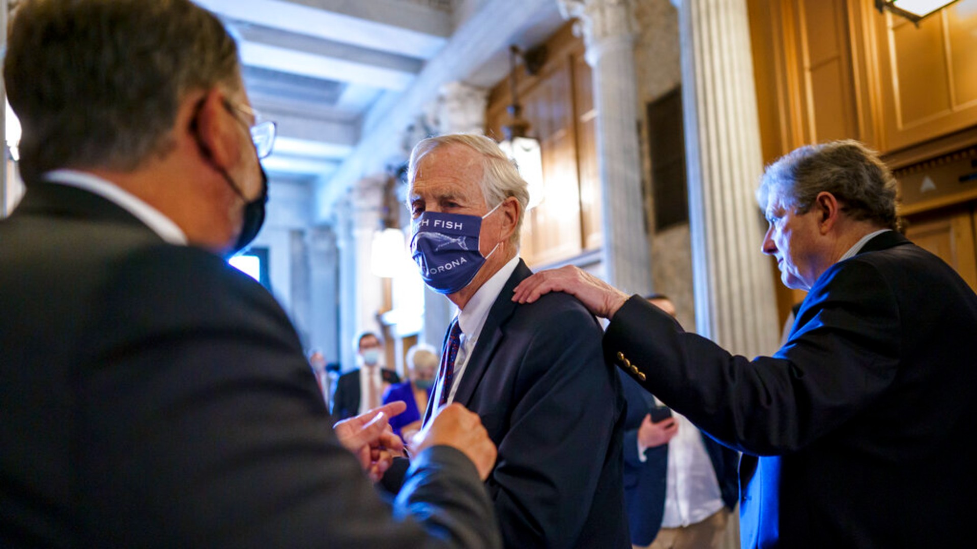 Sen. Angus King, I-Maine, center, speaks with Sen. Gary Peters, D-Mich., left, while Sen. John Kennedy, R-La., walks by at right, as the Senate votes to formally begin debate on a roughly $1 trillion infrastructure plan, a process that could take several days, at the Capitol in Washington, Friday, July 30, 2021. (AP Photo/J. Scott Applewhite)