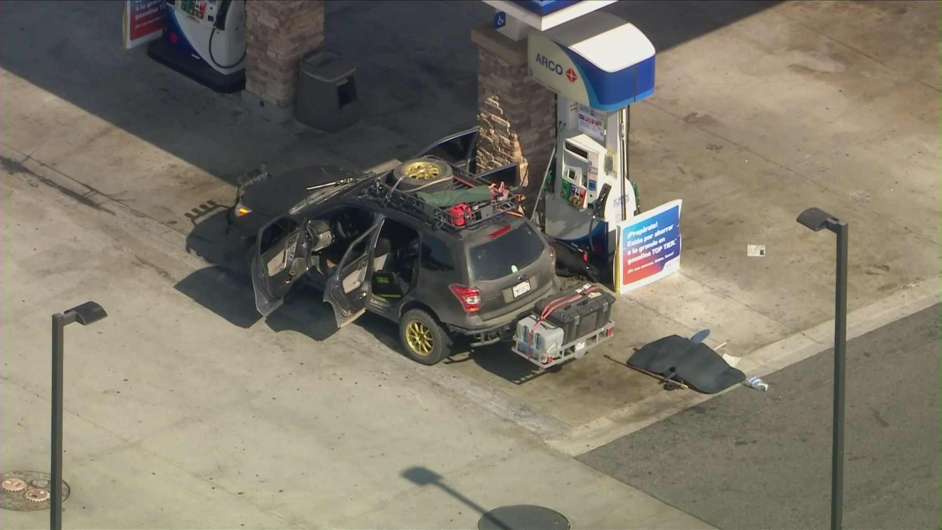 A bomb squad responds to a stolen vehicle at an Arco station in Fontana on Aug. 12, 2021. (KTLA)