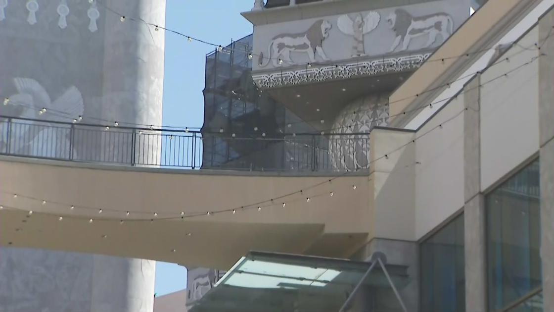 An elephant statue at the Hollywood and Highland complex is covered up on Aug. 4, 2021 as workers get ready to remove it amid its controversial symbolism. (KTLA)